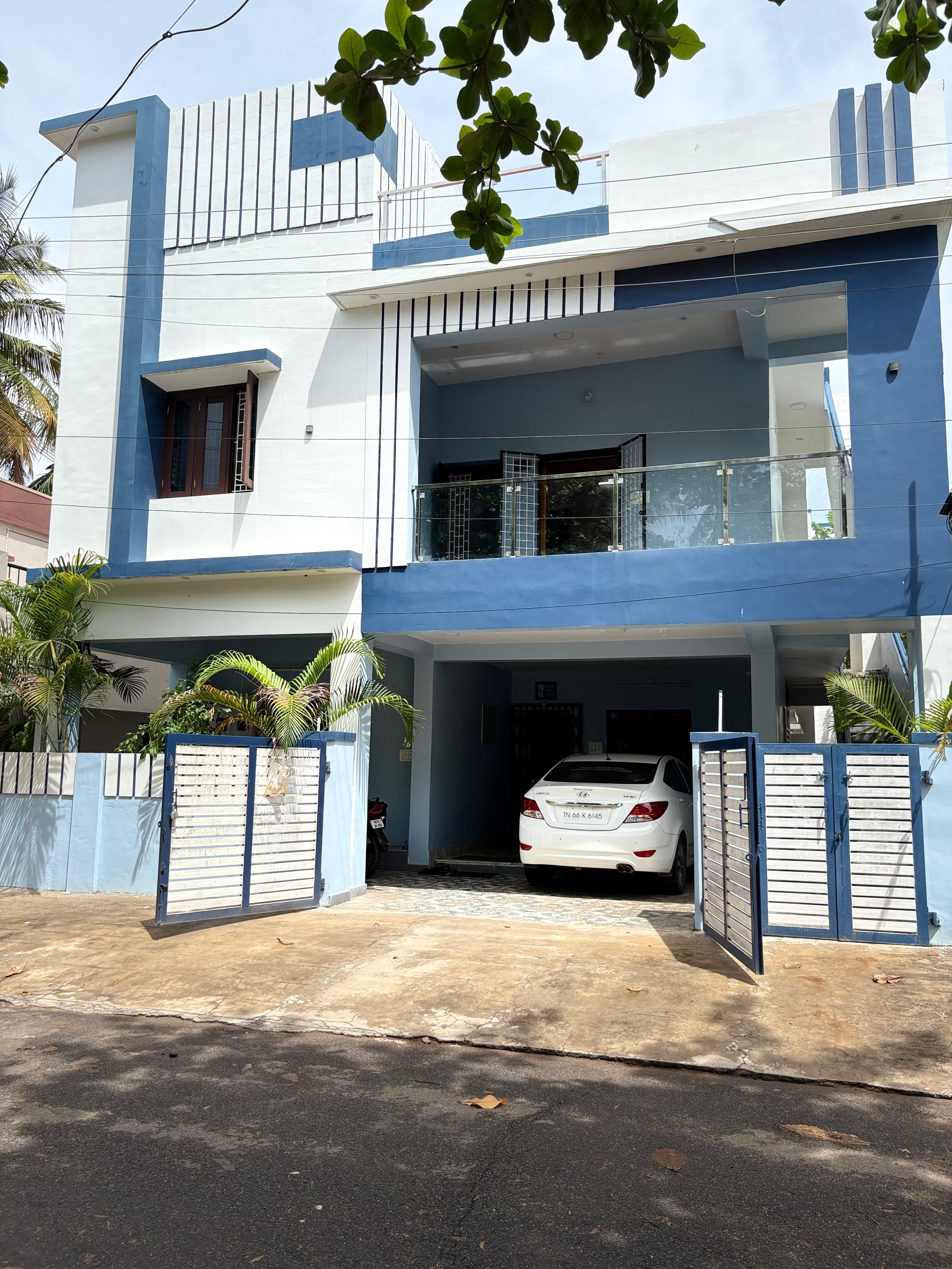 Simon Cottage exterior — a two-storey house with balcony and car parked in the driveway