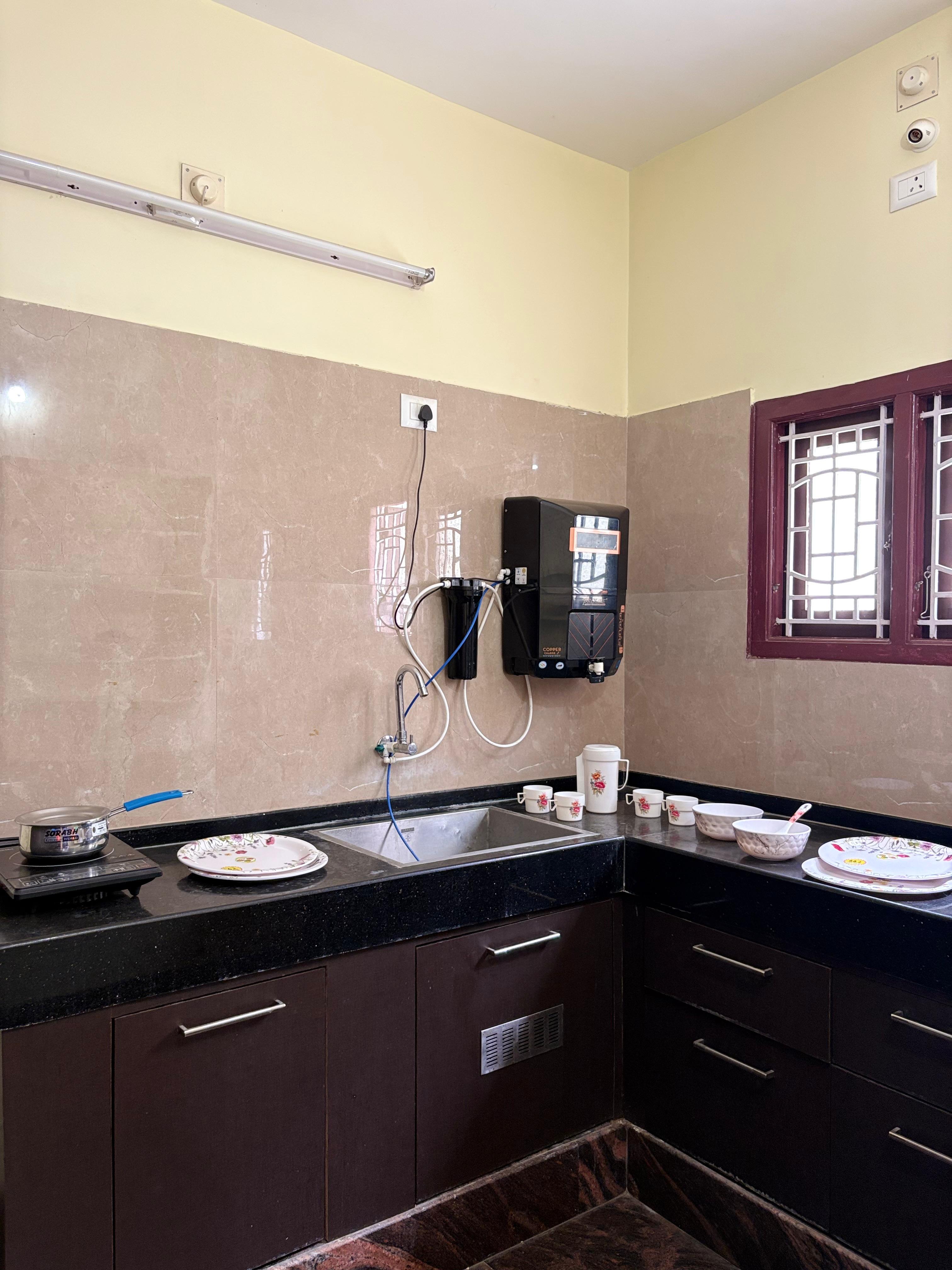 Kitchen with granite counter, sink and water purifier