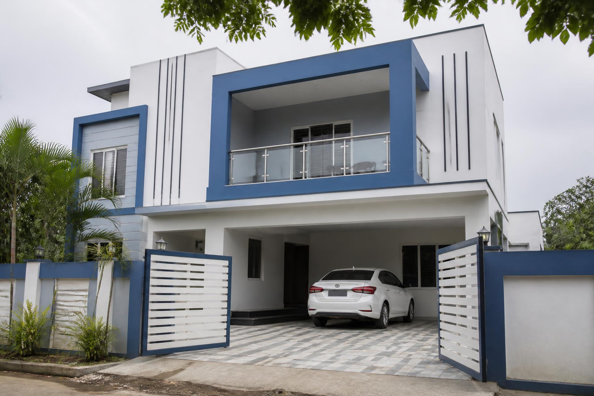 Simon Cottage front exterior — a two-storey house with balcony and car parked in the driveway